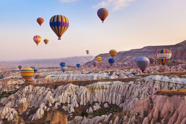 Hot air balloon flying over Cappadocia Turkey Depositphotos 51633651 l 2015