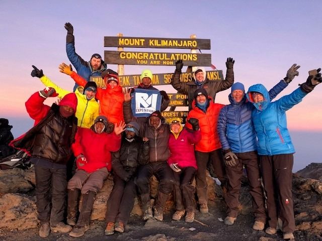 Pa toppen af ​​Mount Kilimanjaro med mine G Adventures rejsekammerater.